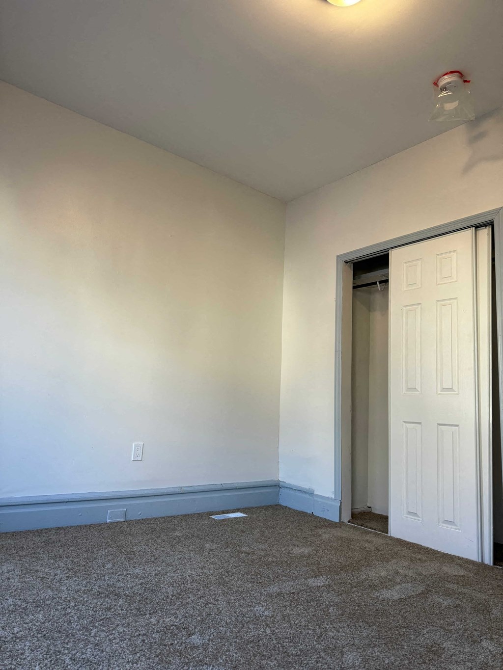 a room with a carpeted floor and a white door