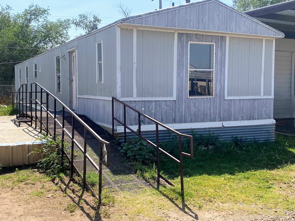 a mobile home with a staircase in front of it