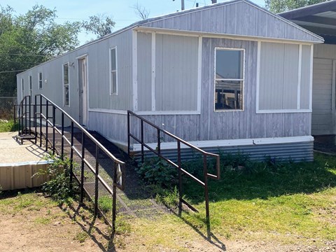 a mobile home with a staircase in front of it