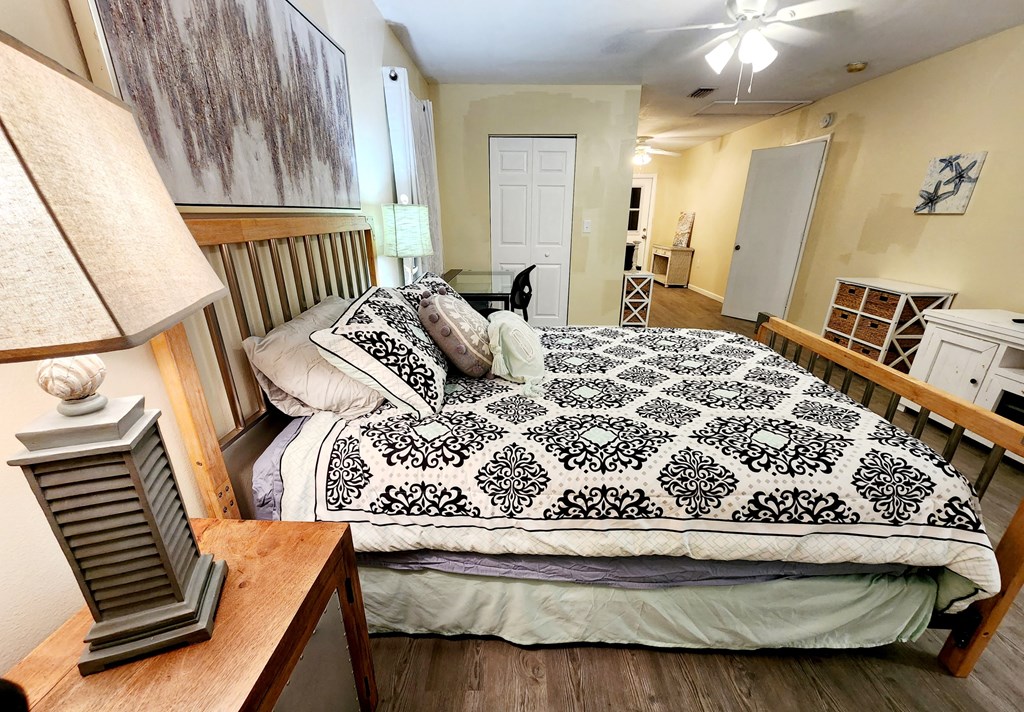view of bedroom and living room from the entrance of the home