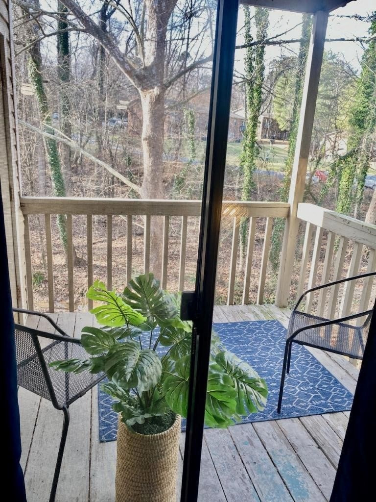 a patio with chairs and a potted plant