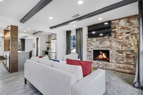 a living room with a couch in front of a fireplace