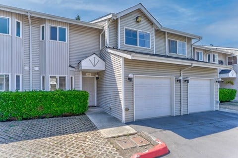 a house with two garage doors and a driveway