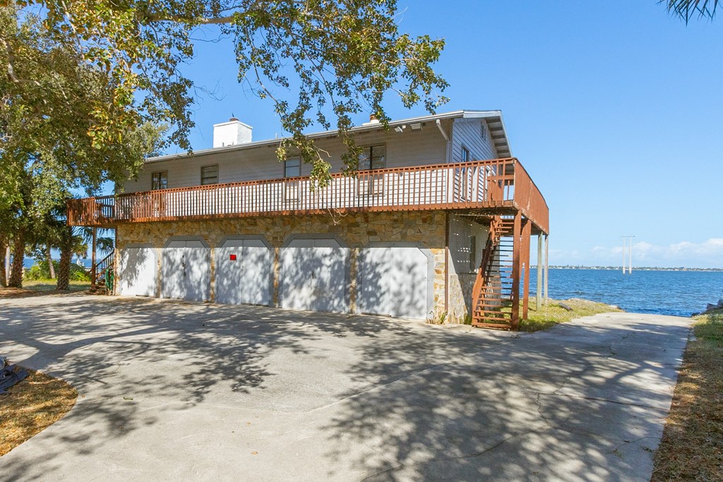 a house with a garage next to a body of water