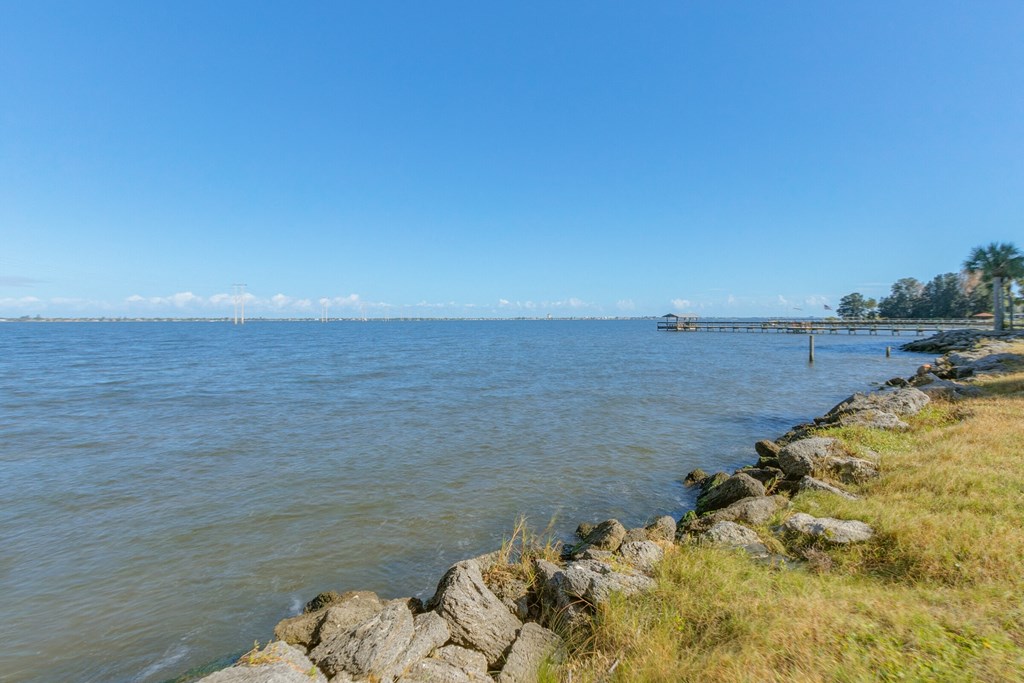 a view of the water with a pier in the distance