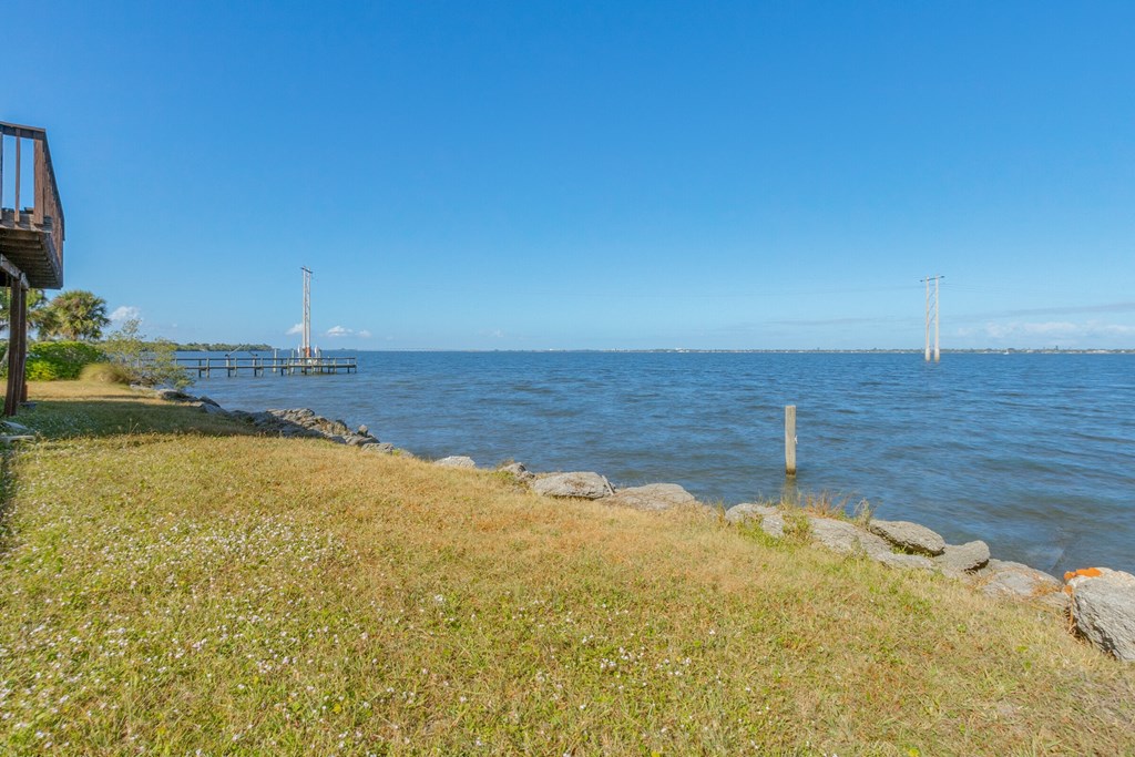 a view of a body of water with a pier in the distance