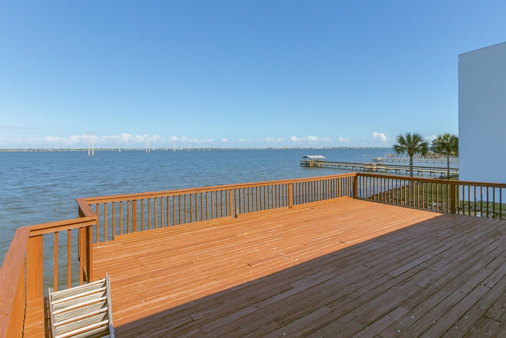 a deck overlooking the water with a dock