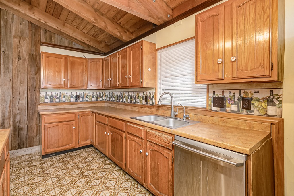 a kitchen with wooden cabinets and a sink