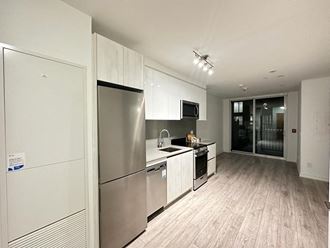 a kitchen with stainless steel appliances and white cabinets