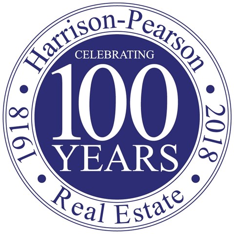 a round seal with the words 100 years of celebrating 100 years real estate
