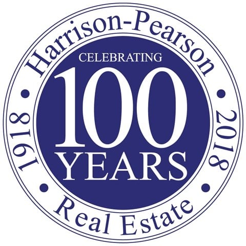 a round seal with the words 100 years of celebrating 100 years real estate