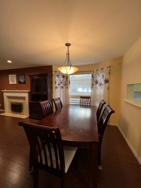 a dining room with a wooden table and chairs