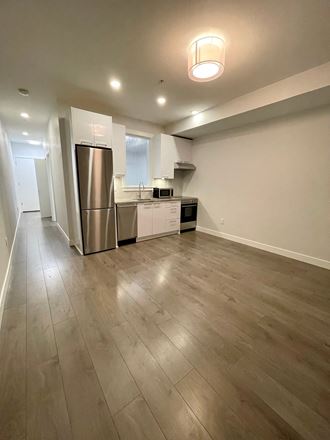 a kitchen with a stainless steel refrigerator and white cabinets