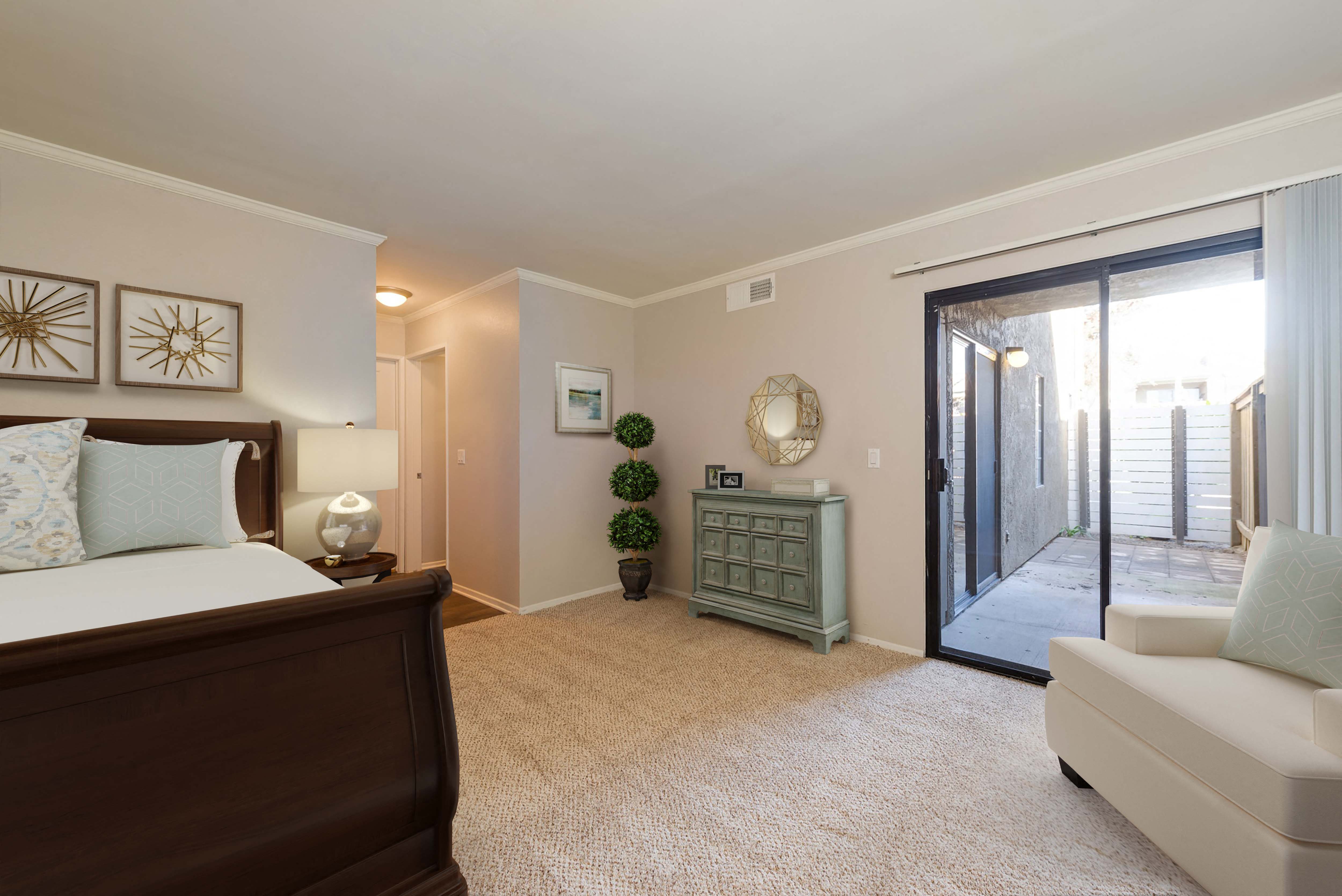 a bedroom with a bed and a sliding glass door