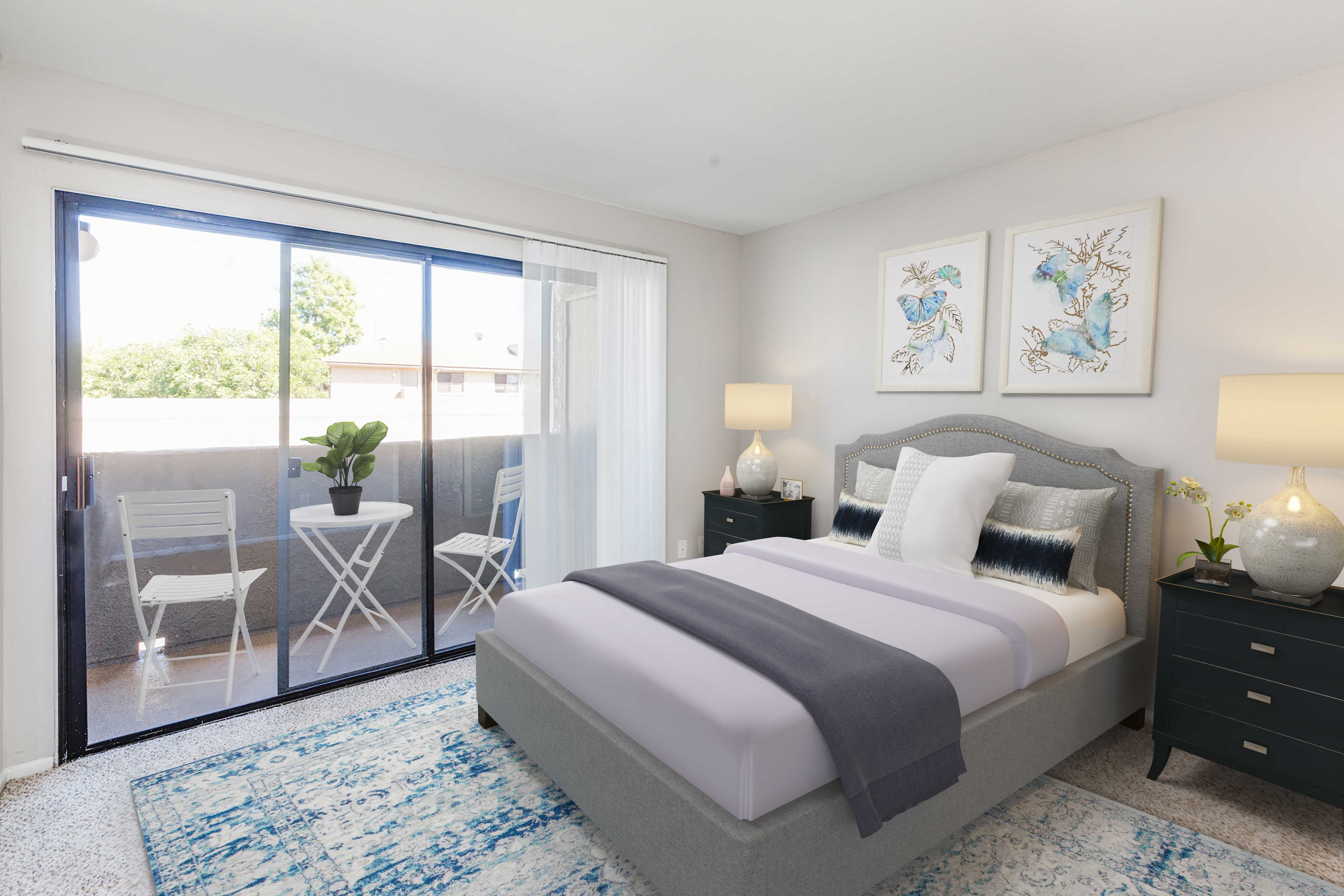 a bedroom with a bed and a sliding glass door