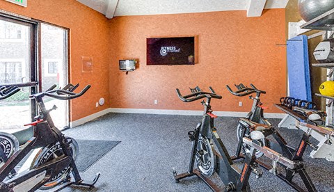 a room with bikes in it and a tv on the wall