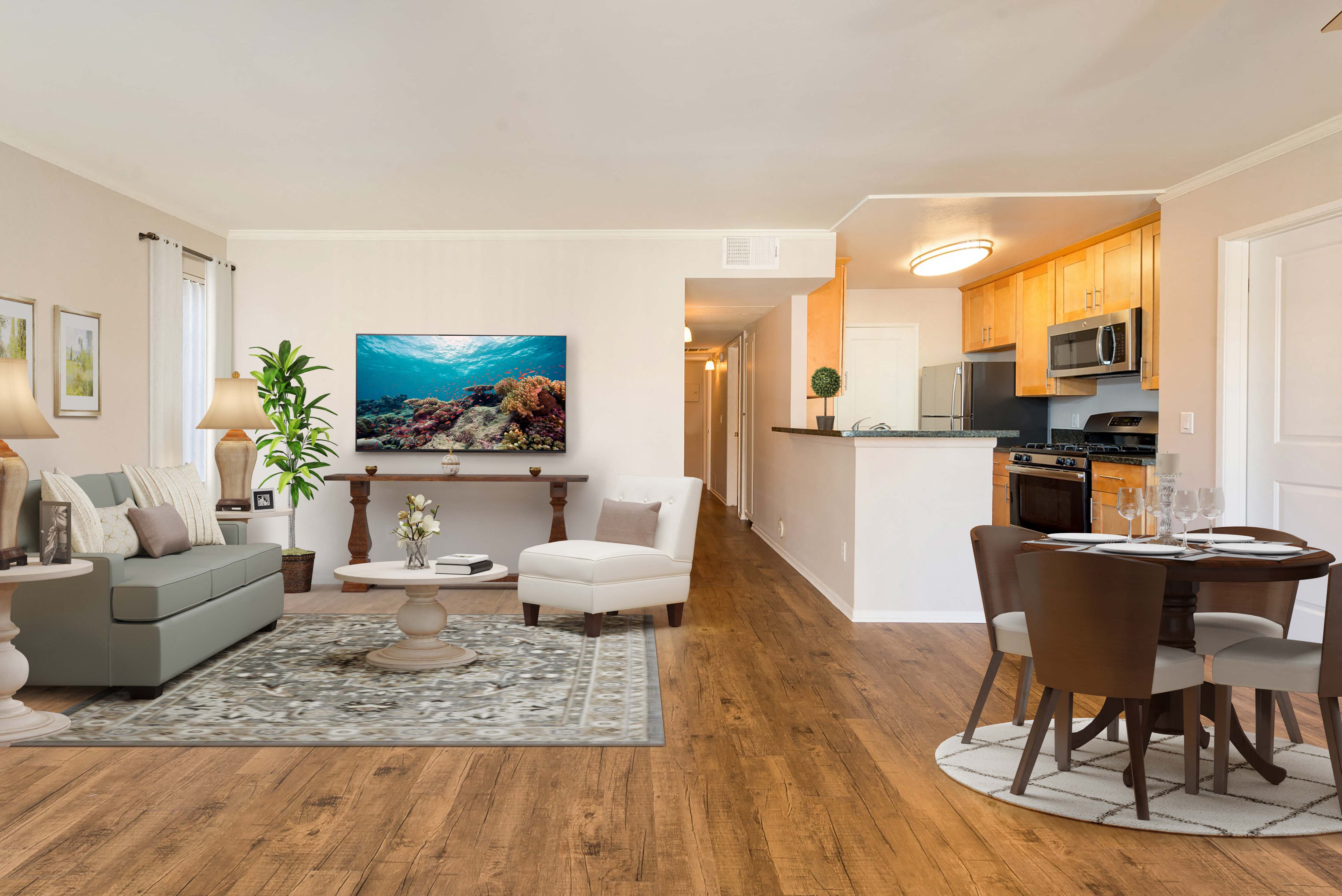 a living room and kitchen with a table and chairs