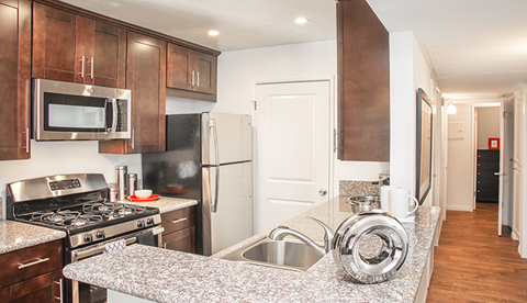 a kitchen with granite counter tops and stainless steel appliances