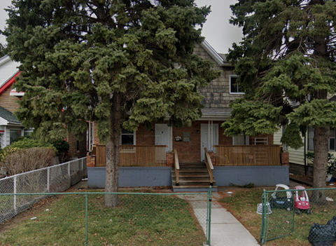 a house with a yard and stairs in front of it