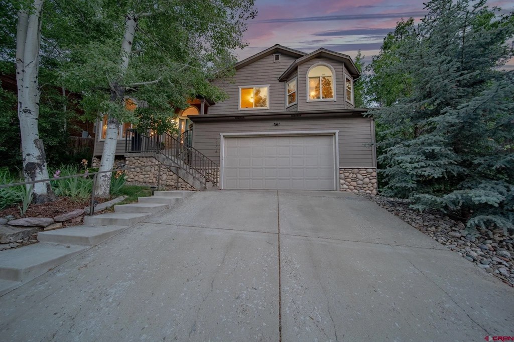 a garage with a white door in front of a house