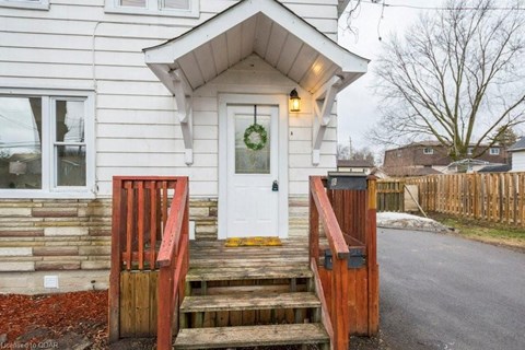 the front door of a house with a porch and a wreath on it