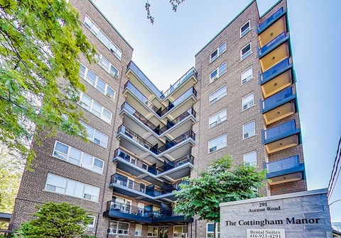 The Cottingham Manor is a rental apartment building with a sign in front of it.