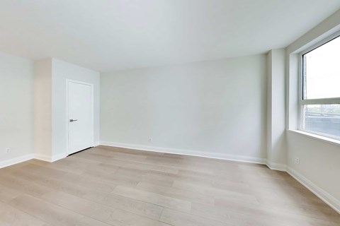 A room with a white door and a window.