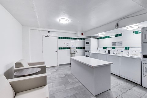 a kitchen with white appliances and a table and chairs