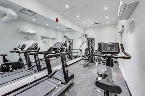 A gym with treadmills and exercise equipment.