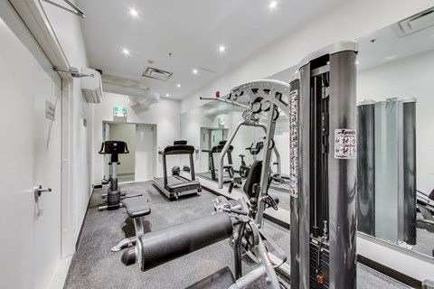 A gym with a variety of equipment including a leg press machine.
