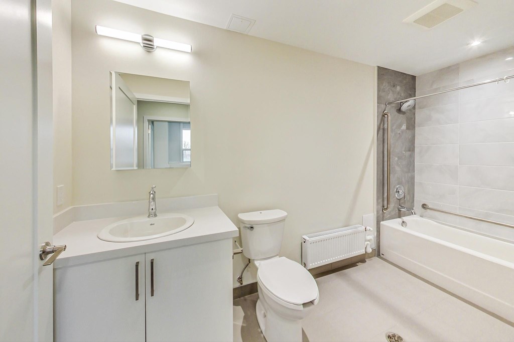 A white bathroom with a sink, toilet, and bathtub.