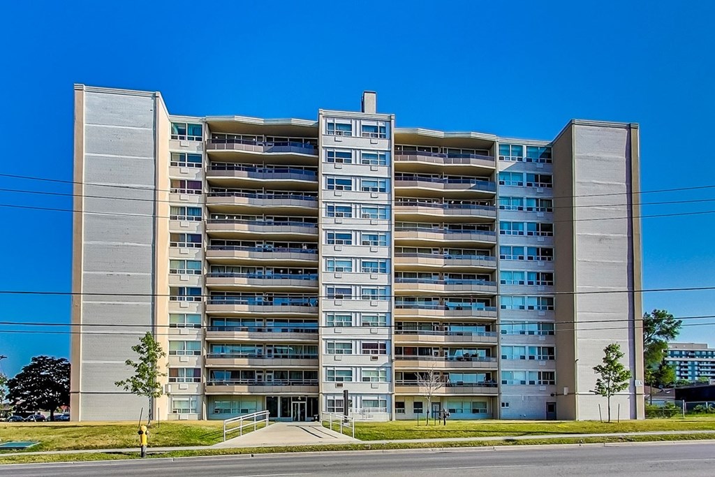 A large concrete building with many windows and balconies.