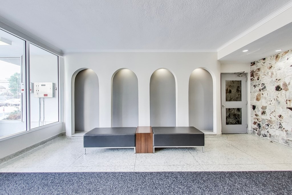 A room with a bench and arched windows.