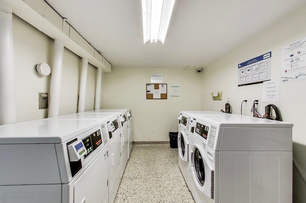 A row of washing machines in a laundromat.