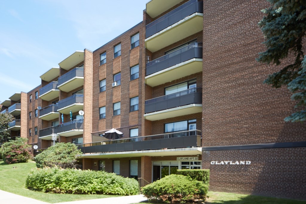 A brick apartment building with the name Clayland on the front.