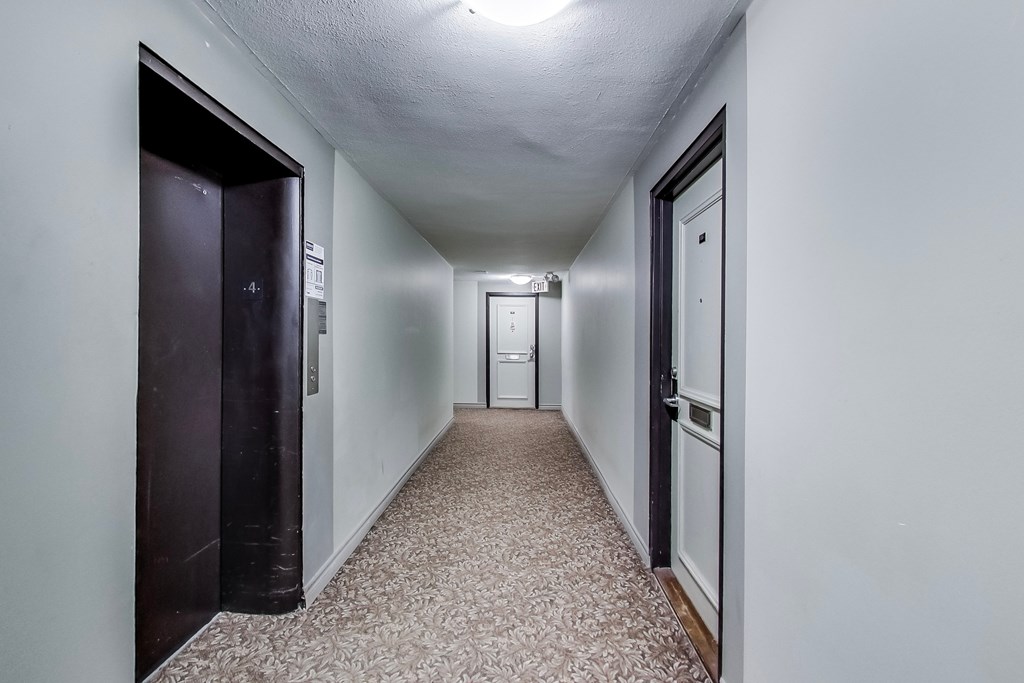 A long hallway with doors on both sides.