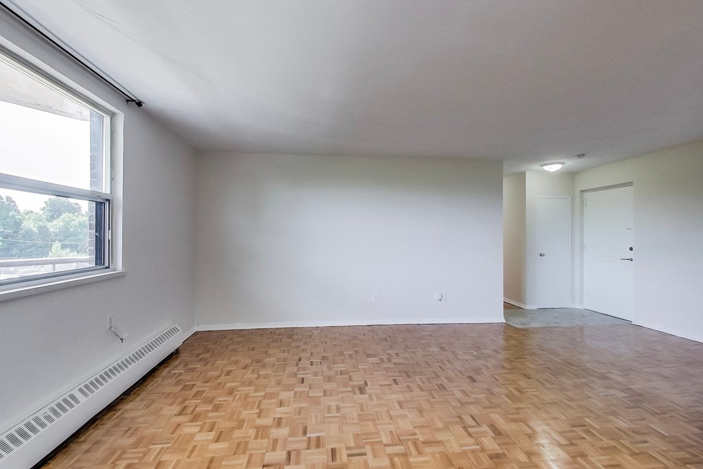 A room with a wooden floor and white walls.