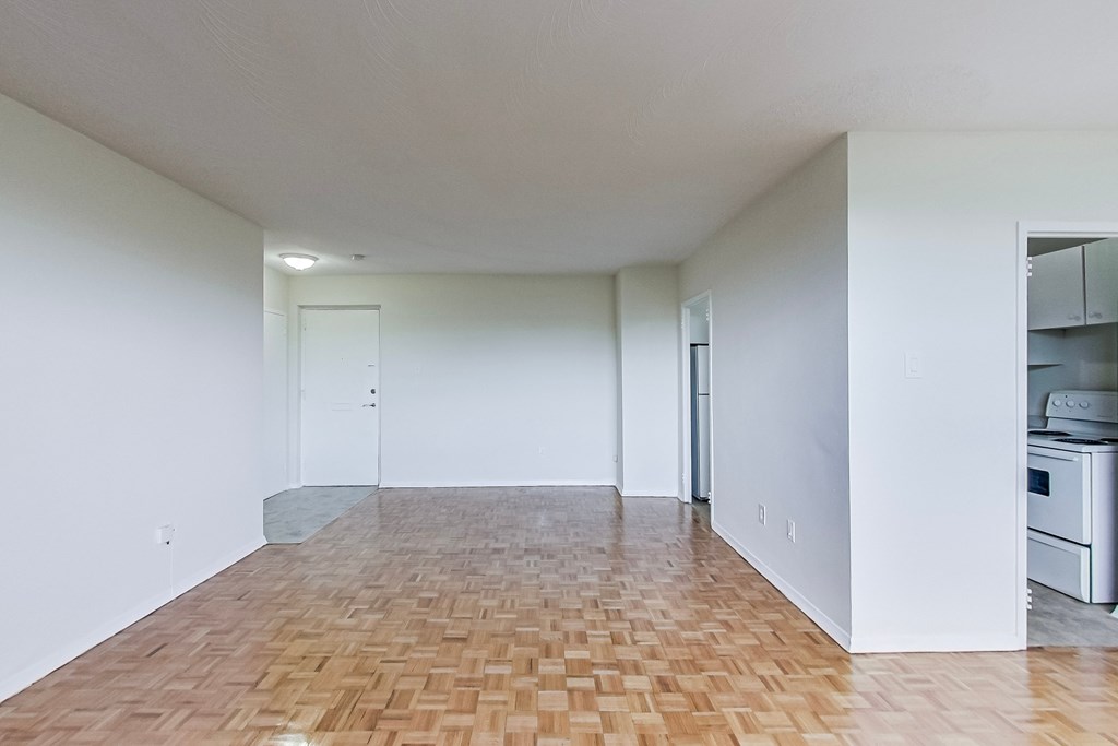 A room with a wooden floor and white walls.