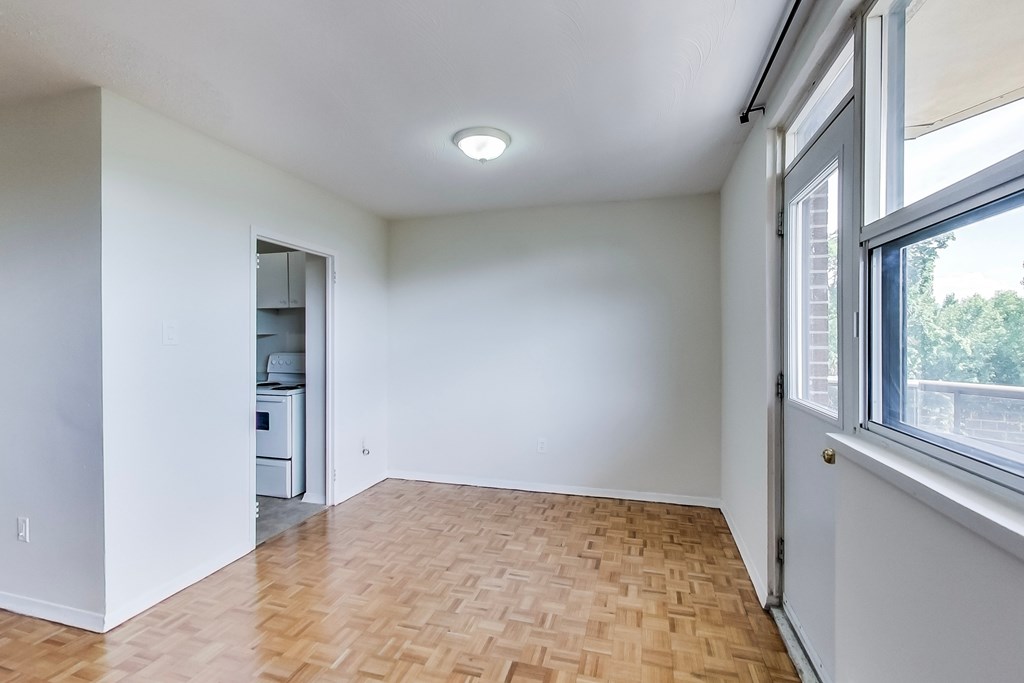 A room with a wooden floor and a window.