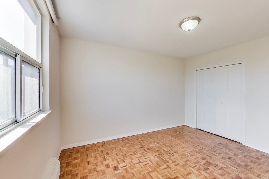 A room with a wooden floor and white walls.
