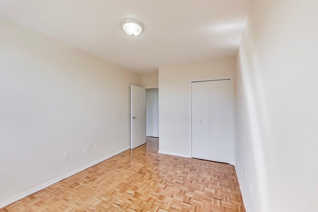A room with a wooden floor and white walls.