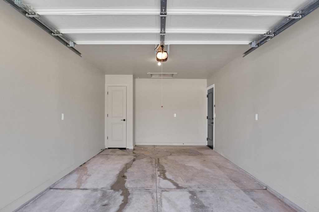 the living room of a new home with white walls and a concrete floor