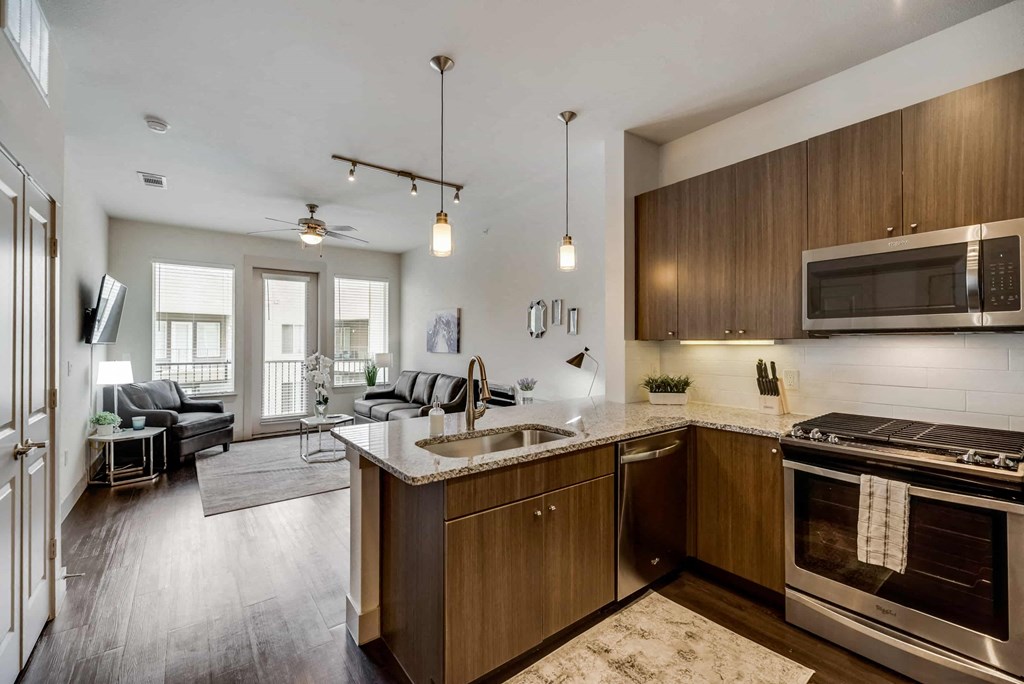 a kitchen and living room with a sink and a microwave