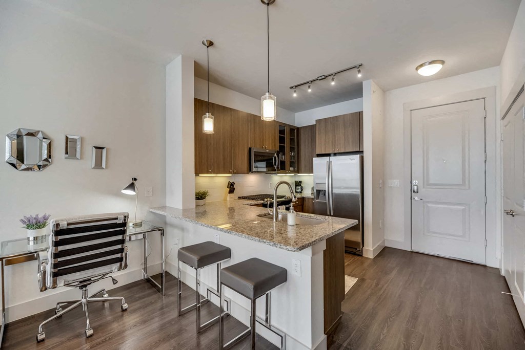 a kitchen with a marble counter top and a sink