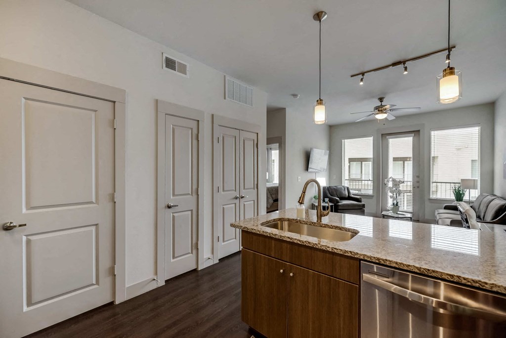 an open kitchen and living room with a counter top