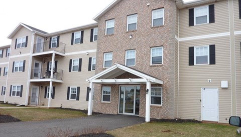 Apartment building with a mix of brick and siding exteriors.
