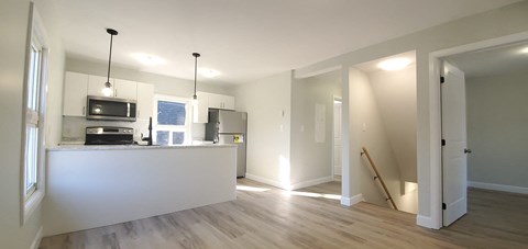 a kitchen with a white counter top and a refrigerator