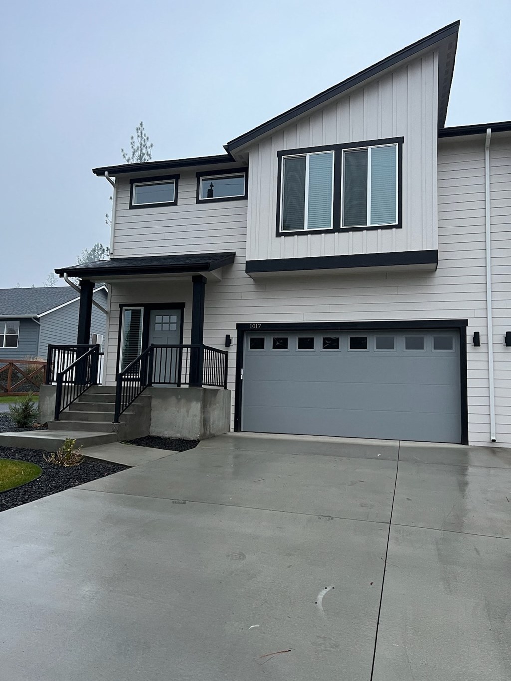 a white house with a driveway and a garage door