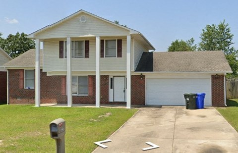 a house with a driveway and a parking meter