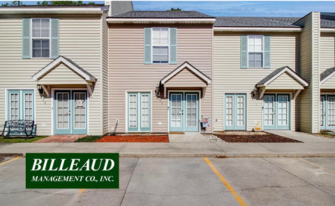 A row of houses with the name Billeaud Management Co. on the front.
